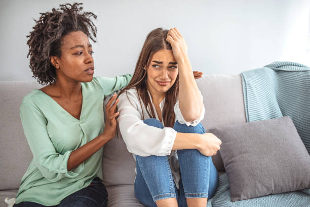 istock Two sad diverse women talking at home. 1317238778
