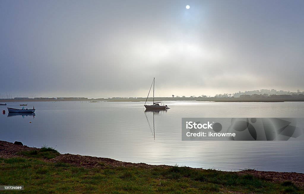 Murky and Misty Dark murky and misty weather with boats in estuary at Calshot, Hampshire UK Anchor - Vessel Part Stock Photo