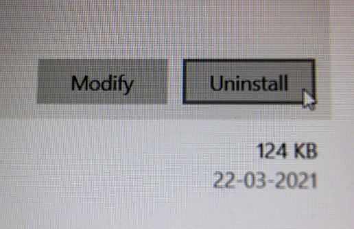 Krakow, Poland - April 01, 2021: Closeup macro shot of a pop up wizard with uninstall and modify permission of a computer software along with a date. Notification on laptop screen.