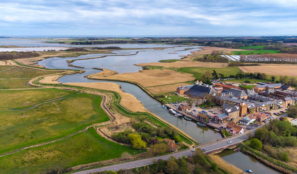 An aerial view of the River Alde at Snape Maltings in Suffolk, UK An aerial view of the River Alde at Snape Maltings in Suffolk, UK east anglia stock pictures, royalty-free photos & images