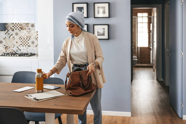 Woman preparing the suitcase before going to work in the morning