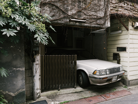 Tokyo, Japan - January 7, 2016: Large  Toyota Crown sedan overhanging its parking place . Toyota Crown 3.0 Twin-cam 24v Super Charger Royal Saloon in Tokyo.