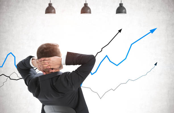 istock Confident businessman looking at rising graphs 1317245612