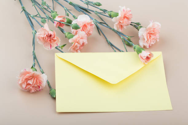 istock Beautiful fresh blooming orange color tender carnations with card. 1317246223