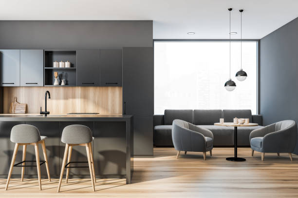 istock Modern kitchen interior with gray walls, a wooden floor and huge panoramic window. A bar table and small dining table with armchairs near it. 3d rendering 1317246415