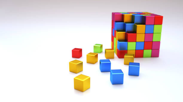 An abstract colorful structure made out of shiny metallic cube blocks on a dark wooden surface