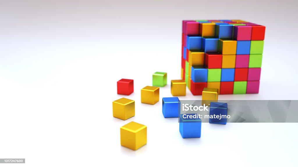 An abstract colorful structure made out of shiny metallic cube blocks on a dark wooden surface Puzzle Cube Stock Photo