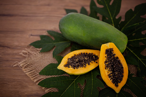 Papaya Fruit on a rustic wooden table.