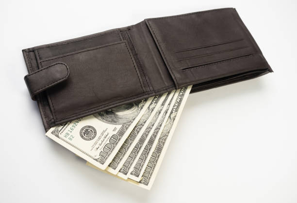istock Leather wallet full of money on white background. 1317248197