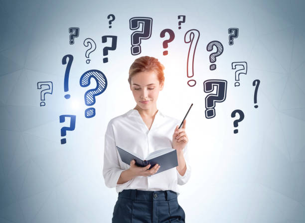 istock Young woman with notebook in hands, question marks sketch 1317248272
