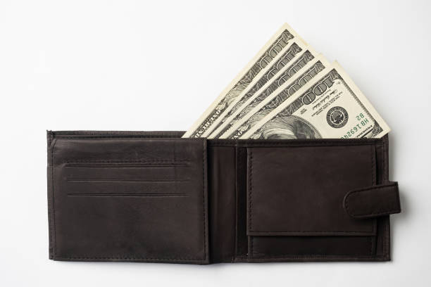 istock Leather wallet full of money on white background. 1317249816