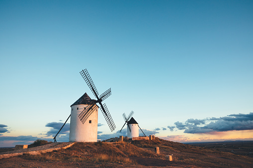 Traditional white windmills (Molinos de Viento Alcazar de San Juan) at sunset (Spain)