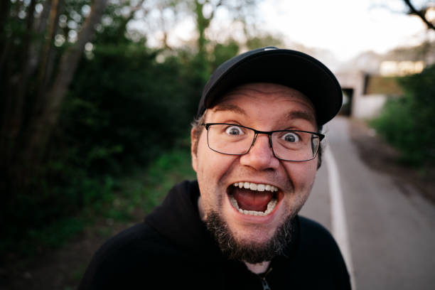 istock Surprised man with ecstatic facial expression outdoors 1317252832