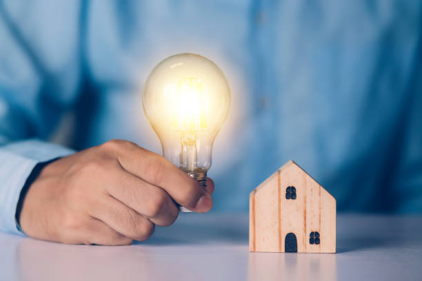 istock Businessman holding light bulb while home wooden for solution innovation and environment, thinking idea for planning buy house, residential with eco and saving energy, business and finance concept. 1317252933