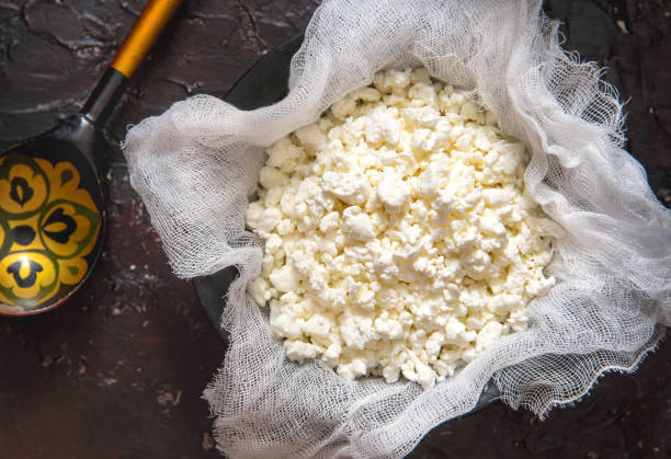 istock Fresh cottage cheese on gauze on a black background 1317252976