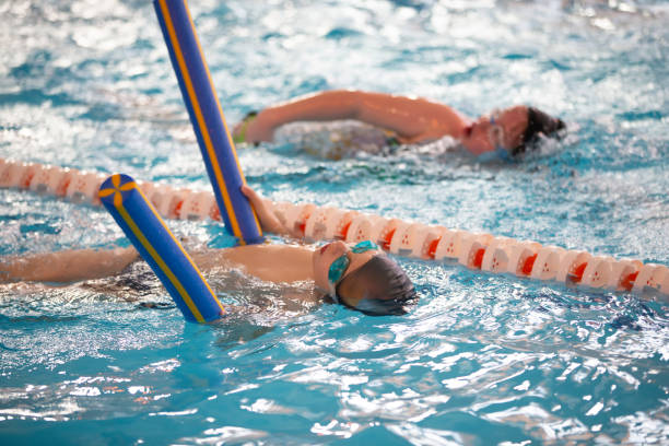istock Child athlete swims in the pool. Swimming section. 1317254012