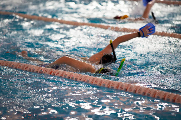 istock Child athlete swims in the pool. Swimming section. 1317254041