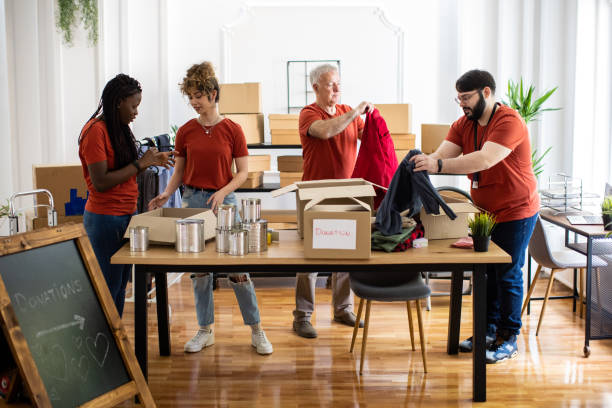 istock Multi-ethnic volunteer team working together at charitable donation center 1317257054