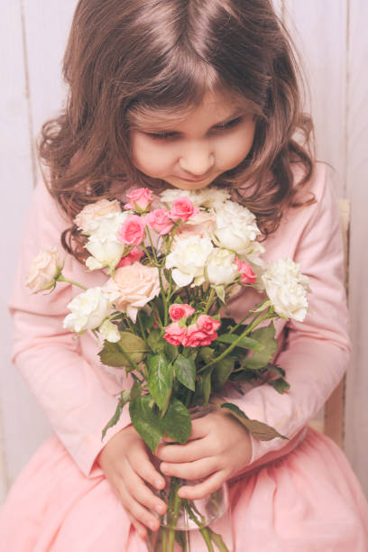 istock Smiling Girl Holding Bouquet While Sitting At Home 1317257545