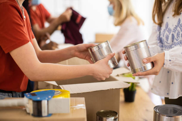 istock Volunteers taking donations from people at charitable donation center during coronavirus pandemic 1317257923
