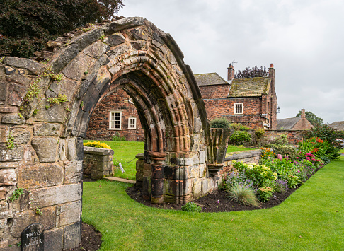 Carlisle Cathedral gardens and ancient archway in the city of Carlisle, Cumbria, UK