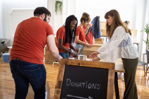 istock Volunteers taking donations from people while working in charitable donation center 1317259182