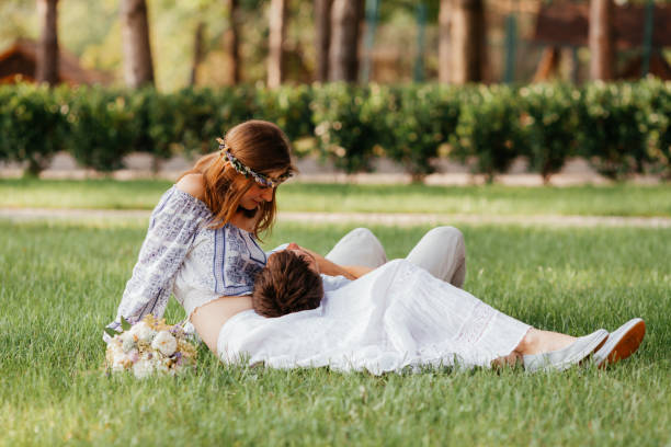 istock Couple Sitting On Grass Outdoors 1317260397