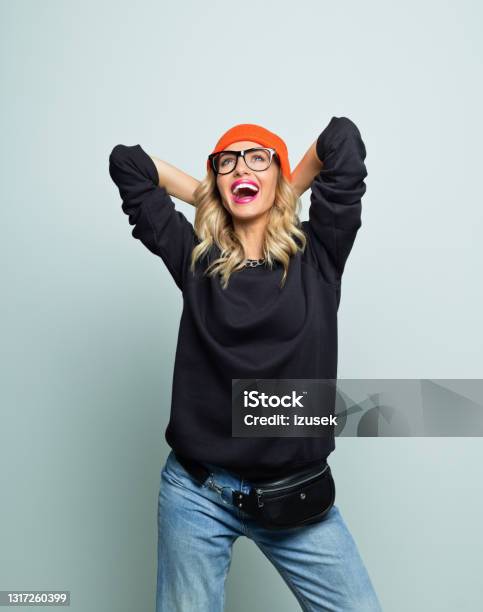 Cheerful Young Woman Laughing With Raised Arms Stock Photo - Download Image Now - Eyeglasses, White Background, Women