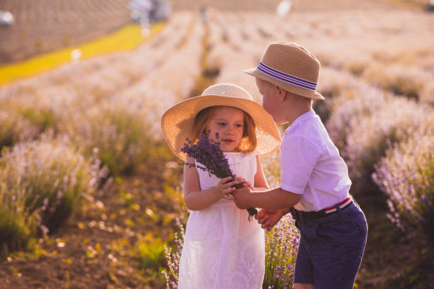 istock Boy And Girl Standing On Field 1317260463