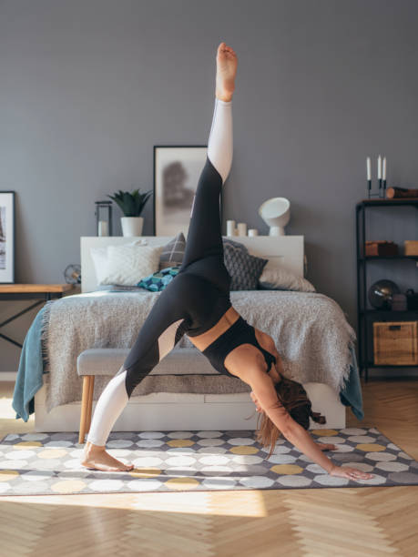 istock Fitness woman practising yoga at home she doing forward bend stretching exercise 1317260991