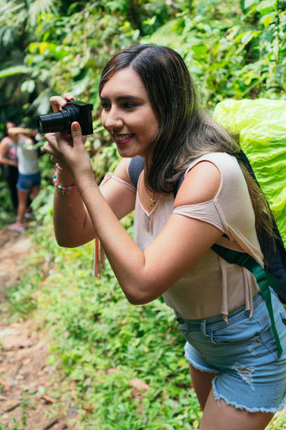 istock Latin Woman Using Camera In Tropical Forest 1317263759