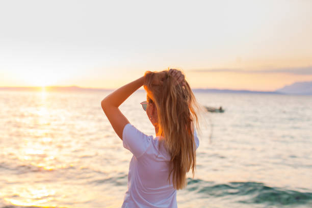 istock Woman Standing At Beach Against Sky During Sunset 1317263822