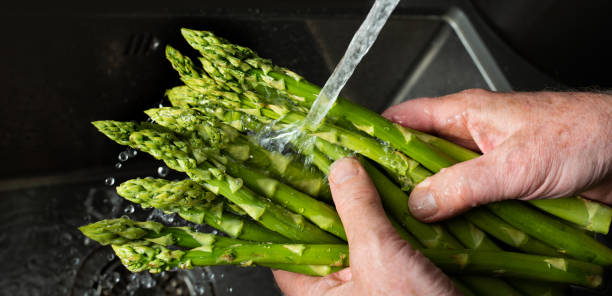 istock Rinse green asparagus with water 1317264136