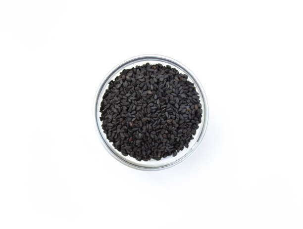 istock Black sesame seed in glass bowl on white isolated background, top view 1317264211