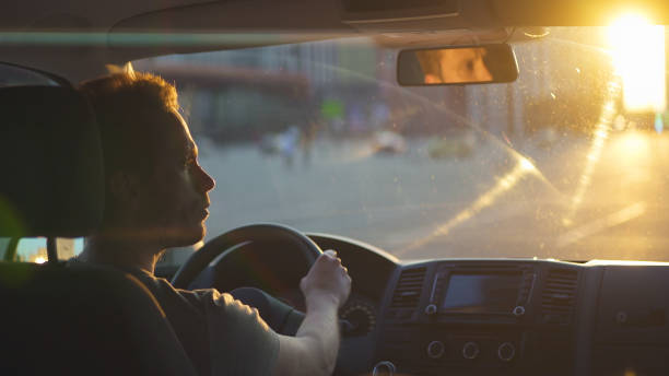 istock The man drives the car on highway on the sunset sky background 1317265662