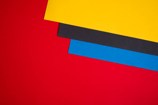 istock Red, yellow, black and blue colored paper background 1317265729