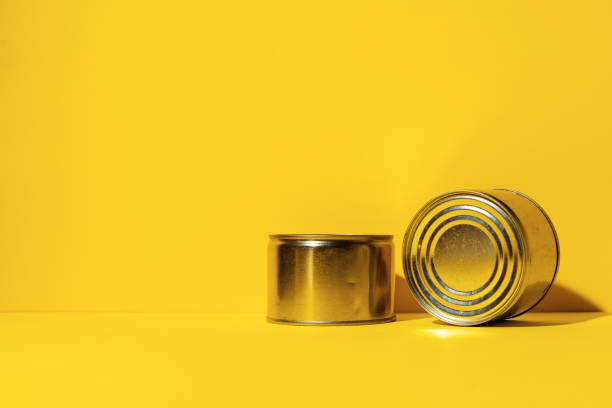istock Canned food tin on yellow studio background 1317265754