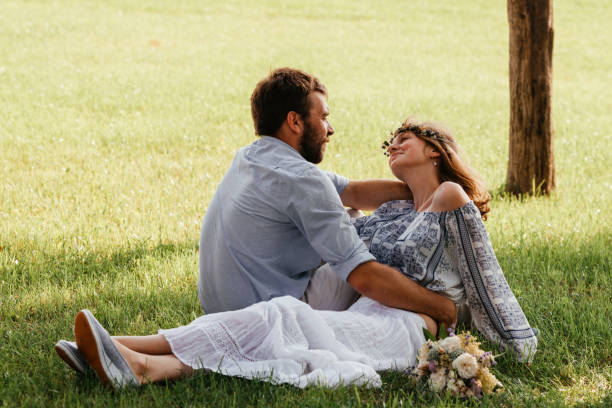 istock Young Couple Sitting On Grass 1317266906