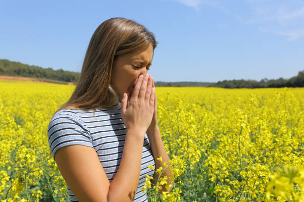istock Allergic woman coughing in a yellow field 1317267025