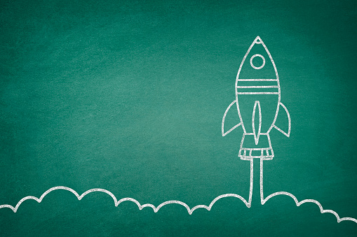 Business startup concept with space shuttle drawing on blackboard
