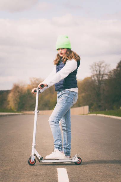 istock Young Girl On Her Scooter 1317267136