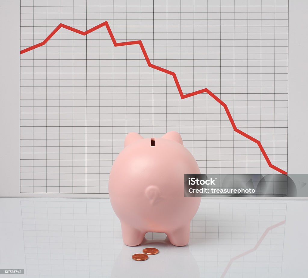 economic downturn pink piggy looking at falling financial chart Accidents and Disasters Stock Photo