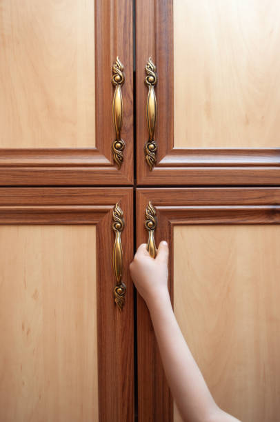 istock Hand opens the closet door 1317268484