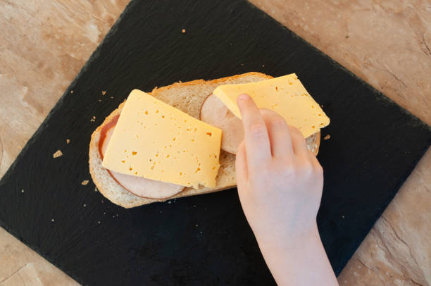 istock Hand children's makes a sandwich 1317268812
