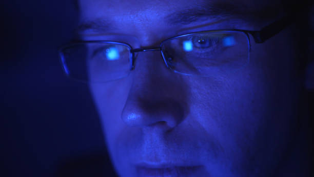 istock Man in glasses with laptop pc in the evening. 1317269137