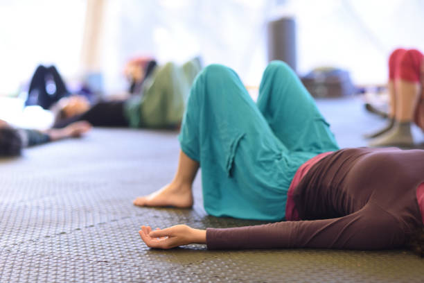 istock People lying down in a group yoga practice, resting. 1317269926