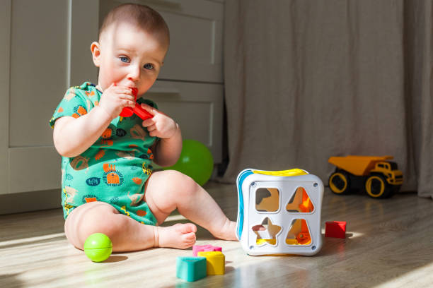 istock Eight-nine month baby boy plays on the floor 1317270034