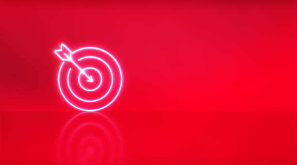 istock Dart hitting a target icon of neon light on red studio background. 1317270493