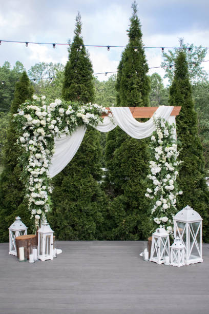 istock Arch for the wedding ceremony, decorated with cloth and white flowers 1317271213