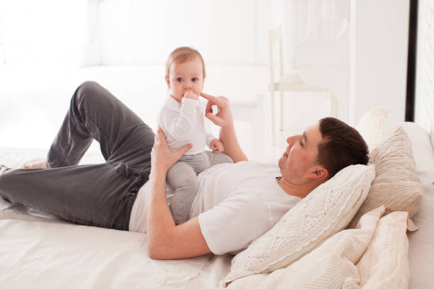 istock Father Playing With Daughter On Bed 1317271364